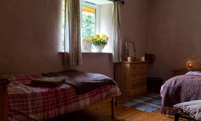 2 twin beds, blankets and hot water bottles, travelling cot.